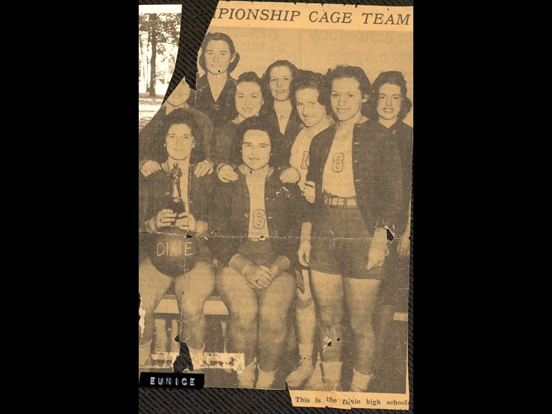 Eunice Erbaugh with the basketball and her high school team